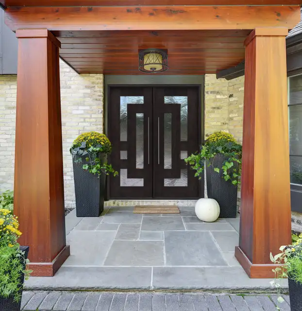 Contemporary home entrance featuring a double mahogany door.